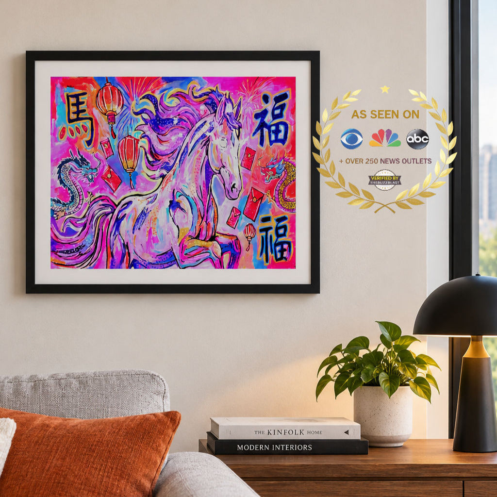 A framed colorful art print featuring a stylized horse with Chinese characters, displayed on a beige wall above a sofa in a living room setting. The artwork has a black frame and a gold 'AS SEEN ON' badge overlay on the right.