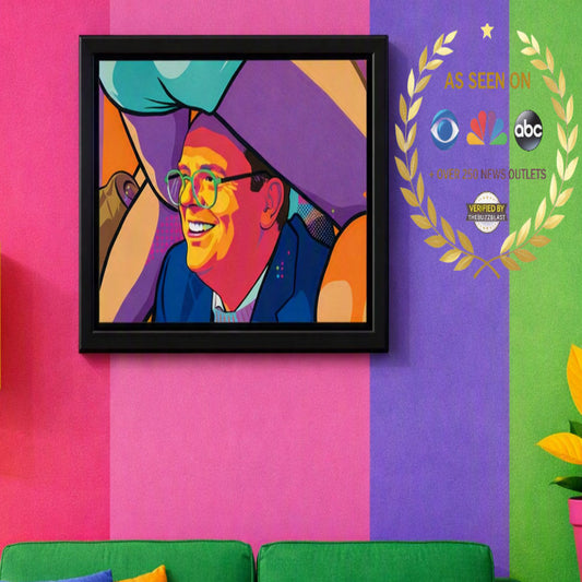A framed pop-art portrait print hanging on a brightly colored wall. The artwork depicts a smiling man in glasses with bold blocks of orange, yellow, blue, purple, and teal.